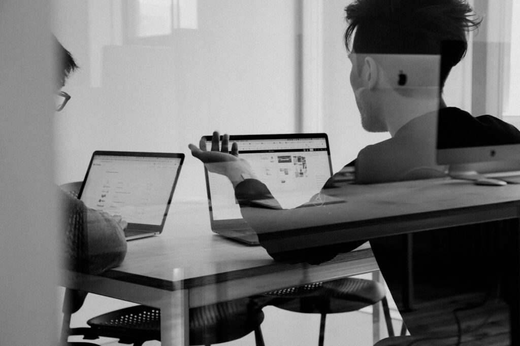 Small team collaborating around a laptop while planning business processes